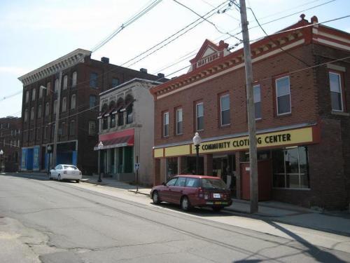 Buildings with cars parked in front of them on the street