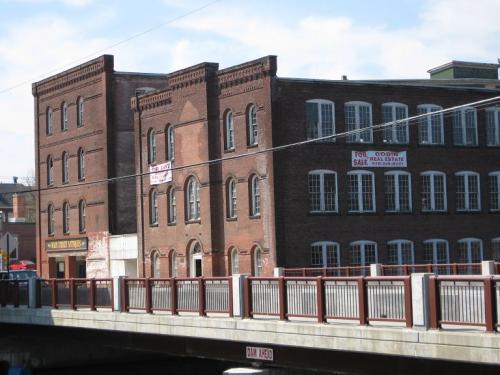 Brown building along the riverfront